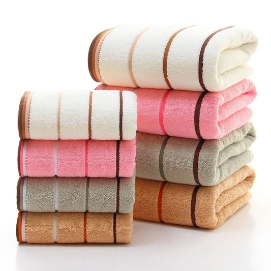 Amiriva Set of 4 colorful combed cotton bath towels laid flat with plaid twill pattern